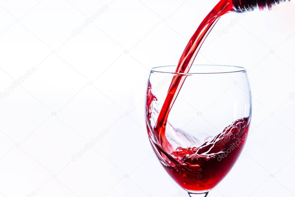 Close up of Red Wine Pouring Into Glass on light background, Alcohol abuse and alcoholism, celebration and party concept. With place for text.