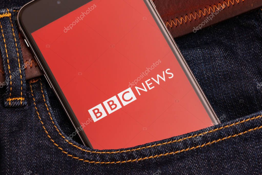Tallinn / Estonia - 02/22/2019: Black phone with red logo of news media BBC News on the screen. News media icon. Denim jeans background