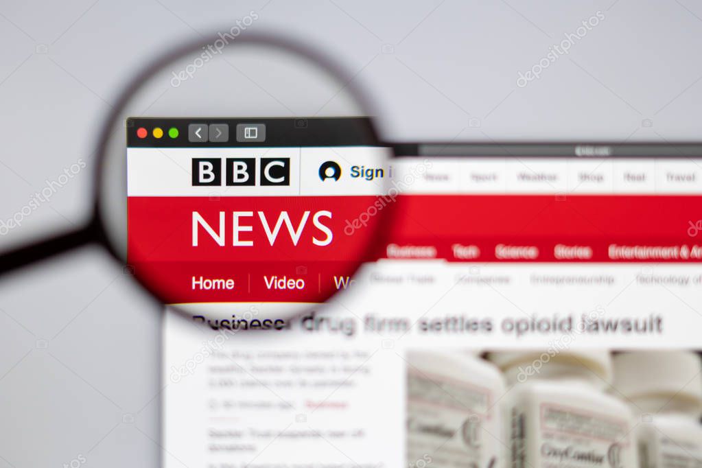 New York, USA - March 26, 2019: BBC News website homepage. BBC logo visible  through a magnifying glass.