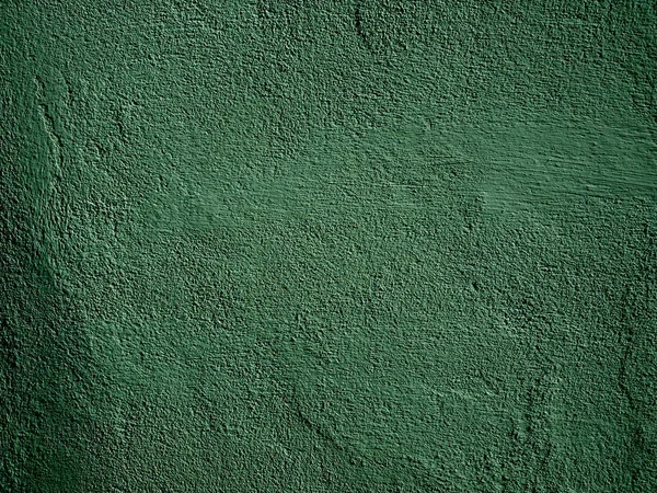 Green concrete wall is a decorative or textured surface. Can be used as a background or for design purposes