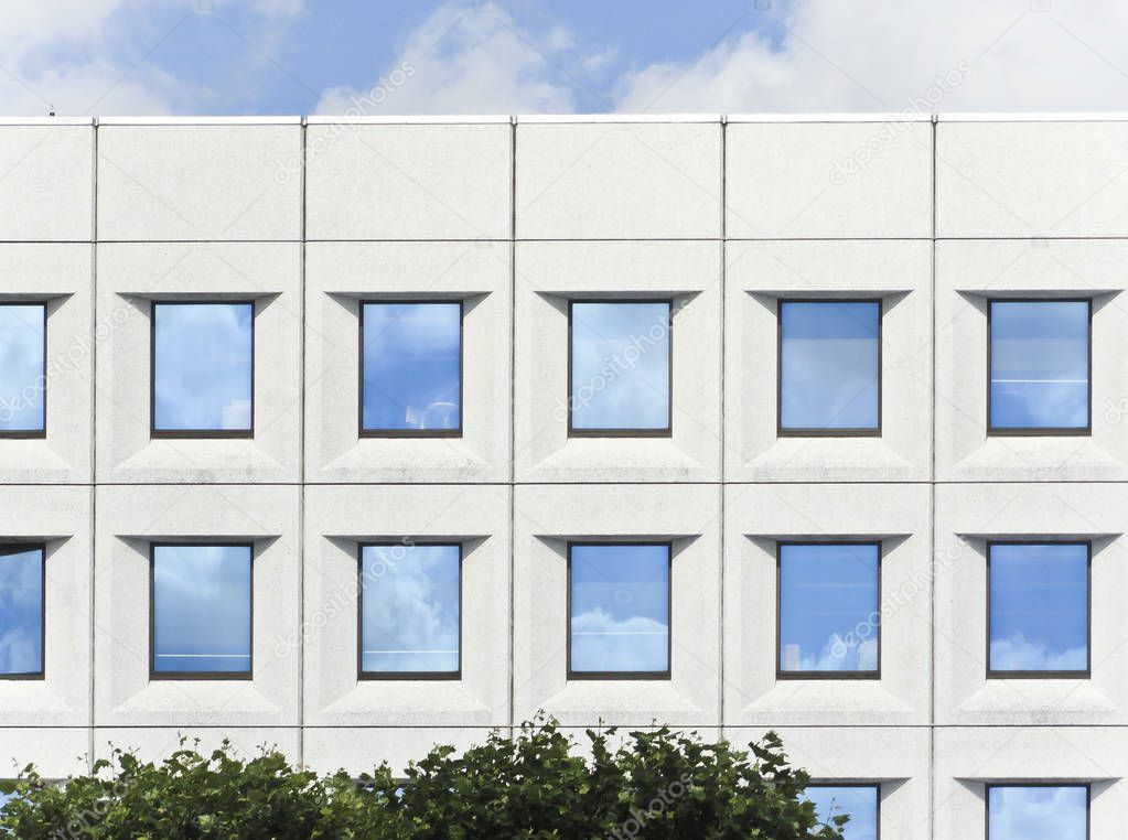 Plain White Office Building with Sky Showing through Windows