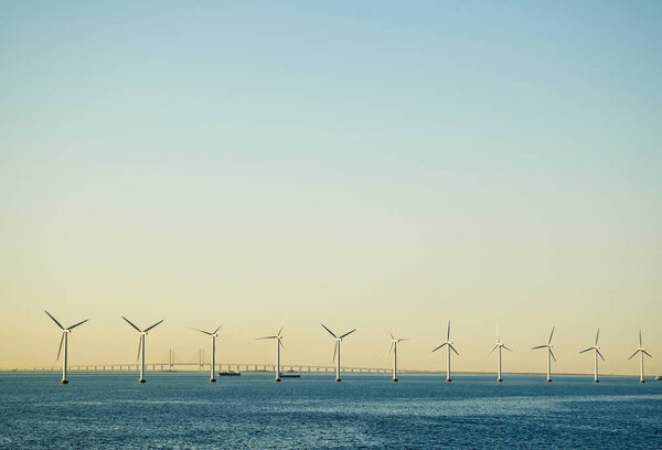 Row of Electricity Generating Windmills in the Ocean