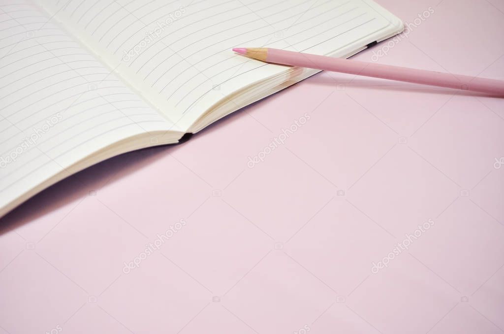 Blank Notebook with Pencil on Pink Background
