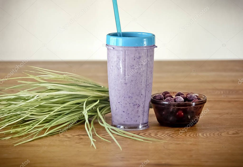 Purple Smoothie with Bowl of Blueberries on a Wood Table