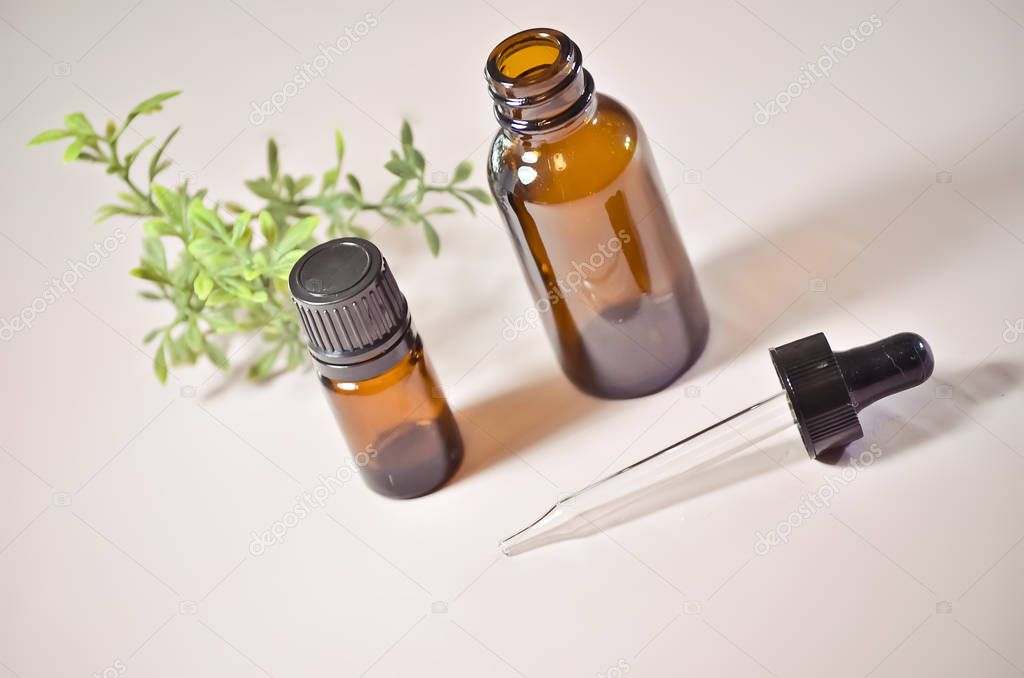 Essential Oil Bottles with Eyedropper on Pink Background