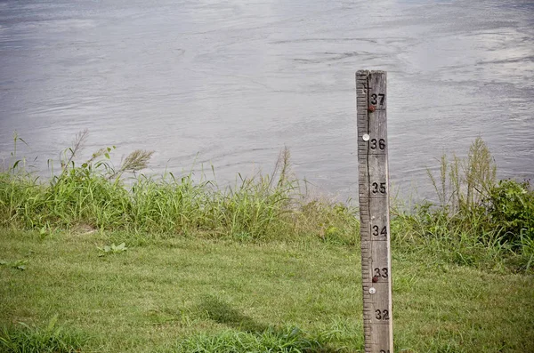 Water Level Measuring Stick next to a River