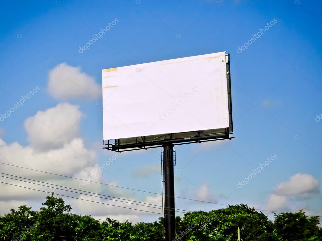 Plain White Billboard with Blue Sky Clouds and Trees