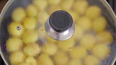 Bir tavada kavurma patates. Patates tatlı. Bir adam Aşçılar ve patates çevirir.