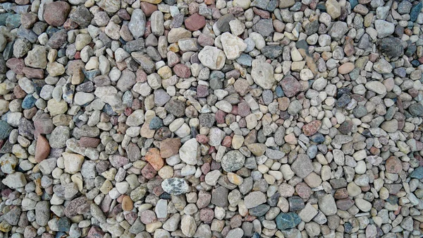 Taşların dokusu. Pürüzsüz Cilalı Taşlar Plaj Arka Planda Kıyıya Yıkanmış.