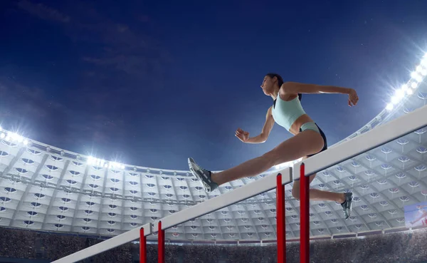 Female athlete on professional athletics stadium.