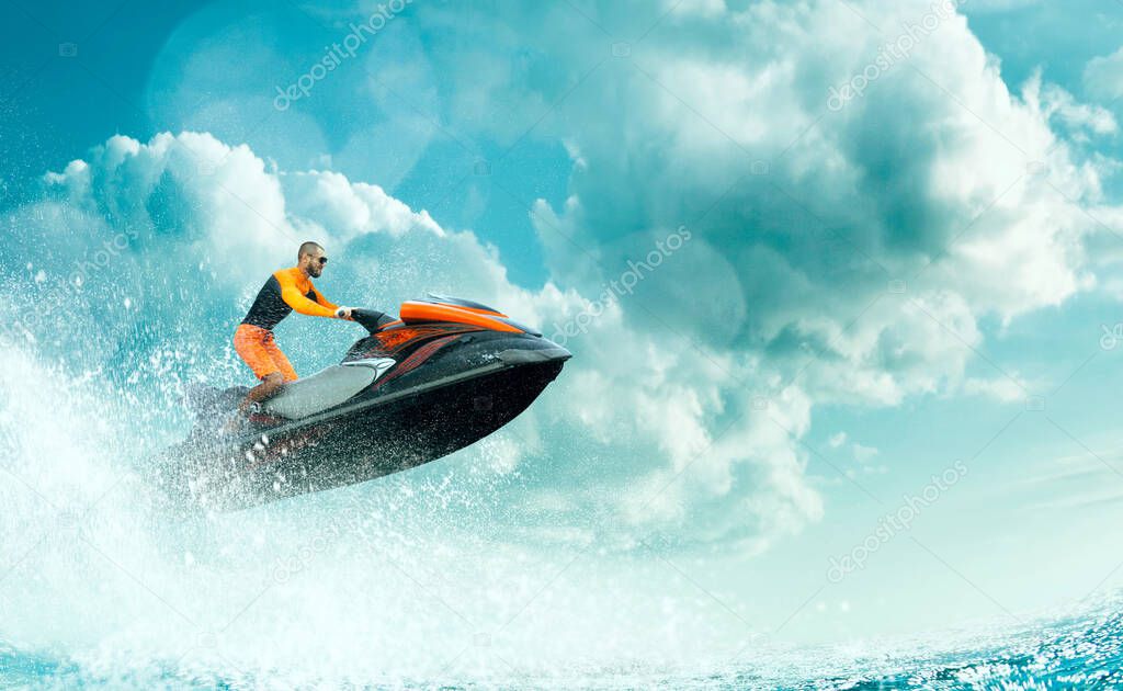 Young Man on water scooter in tropical ocean.