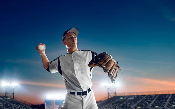 Baseball player at professional baseball stadium in evening duri