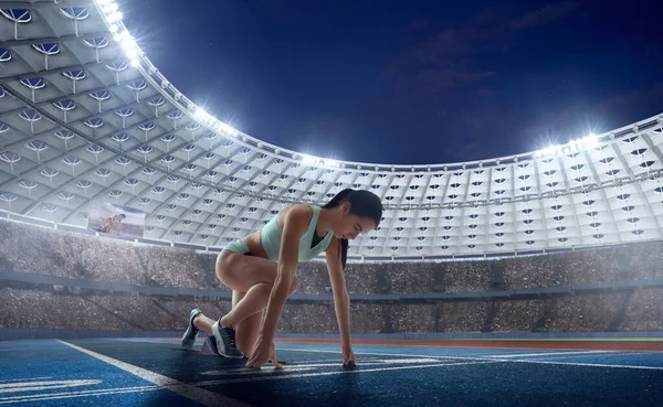Female athlete on professional athletics stadium.