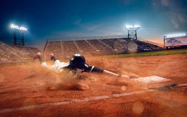 Baseball player at professional baseball stadium in evening duri