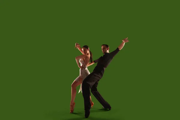 Couple dancers  perform latin dance on wgreen screen background.