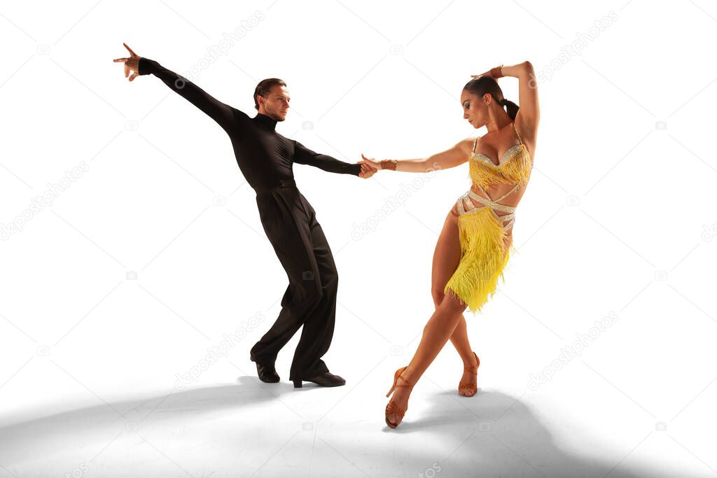 Couple dancers  perform latin dance on white background.