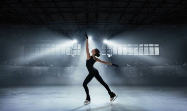 Figure skating girl in ice arena. clipart