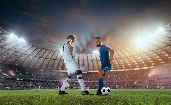 Soccer players in action on professional stadium.
