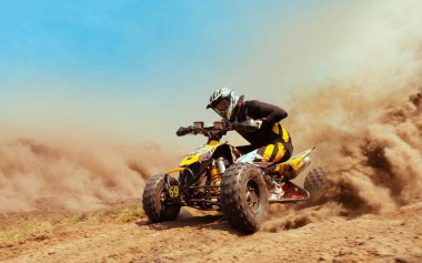 Quad bike in dust cloud, sand quarry on background. ATV Rider in clipart