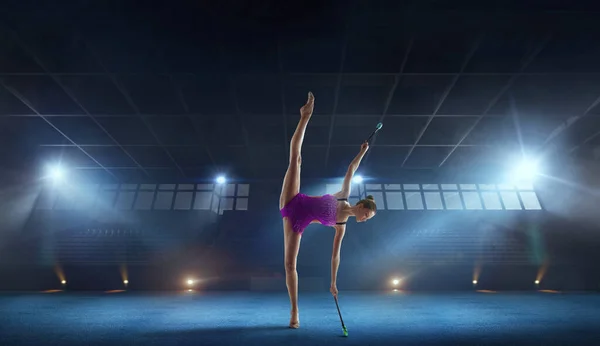 Girl performing rhythmic gymnastics.