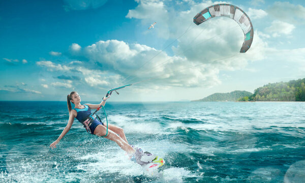 Young woman kite surfing.