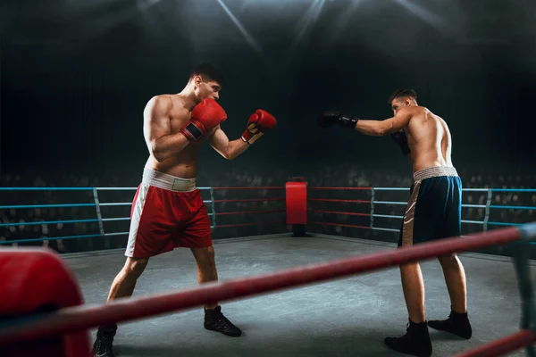 Two young men boxing.