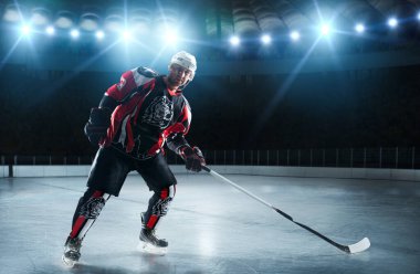 Ice hockey player at arena. clipart