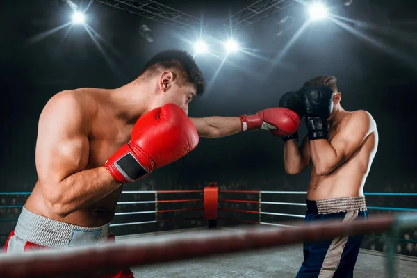 Two young men boxing.