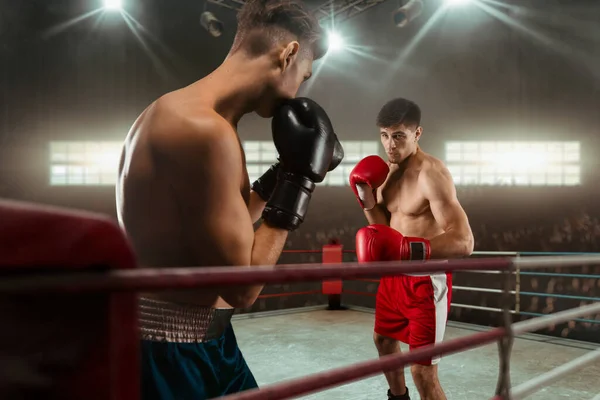 Two young men boxing.