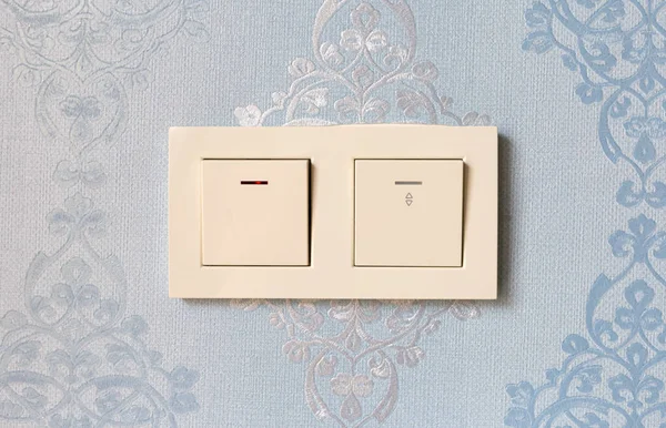 Light switch on the wall. Wall with a double electric switch.