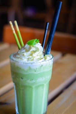 çırpılmış krem nane yaprakları çikolata sopa ile harmanlanmış matcha latte