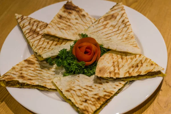 Arayes Flat Lebanese bread stuffed with lamb or chicken minced meat and served with garlic yoghurt sauc