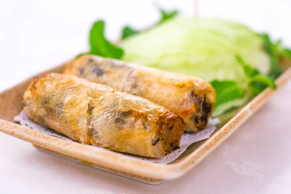Deep fried Vietnamese Spring Rolls wrapped by fresh lettuce
