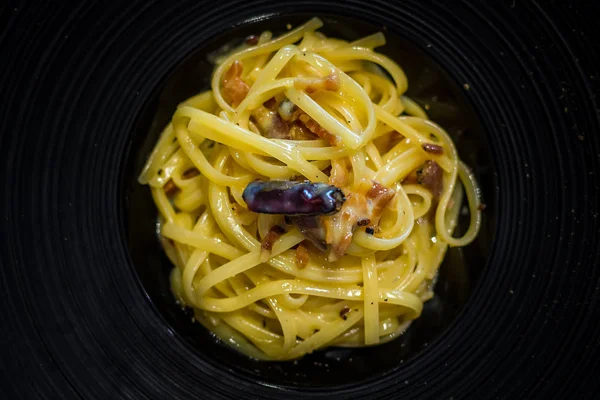 Linguine tossed in crispy bacon, egg, parmigiano and a light touch of chilli