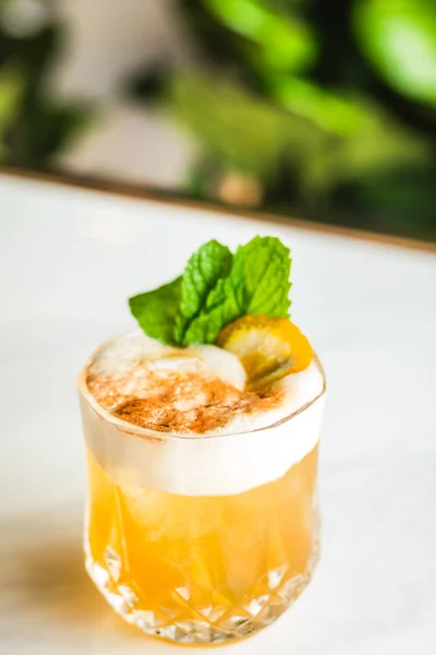 Cocktail with orange bitter and orange peel and mint leave — Stock Photo, Image