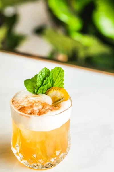 Cocktail with orange bitter and orange peel and mint leave — Stock Photo, Image