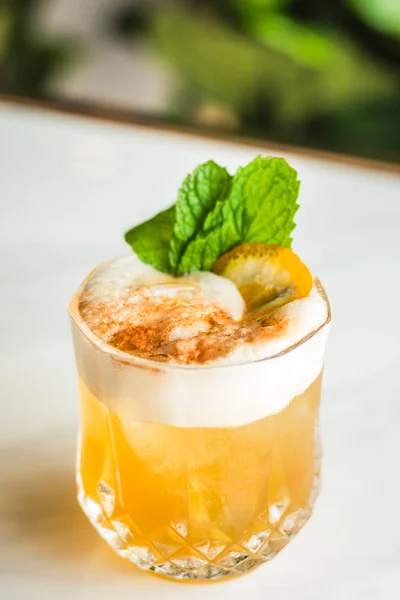 Cocktail with orange bitter and orange peel and mint leave — Stock Photo, Image