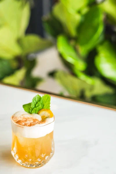 Cocktail with orange bitter and orange peel and mint leave — Stock Photo, Image