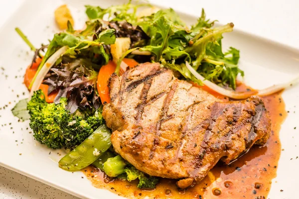 Pork Neck Fillet Steak Very tender and juicy pork collar steak served with garden veggies.  Choice of mushroom/ black pepper sauce. — Stock Photo, Image