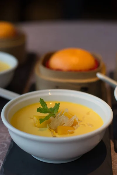 Puré de mango refrigerado con pedacitos de Pomelo y hojas de menta y servido con pan de crema dorada —  Fotos de Stock