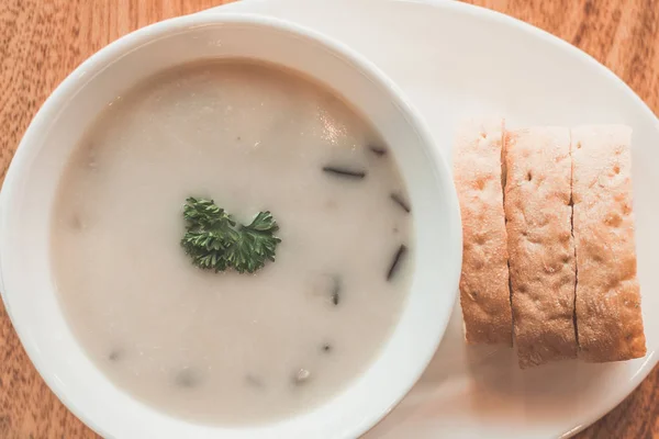 Cream of mushroom soup and garlic bread on the side — Stock Photo, Image