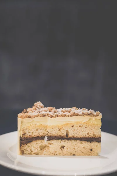 Jaffa Cake Vanilla pound cake sandwiched between rich chocolate mousse, orange jam and mousse.ine, topped with almond butter crumble