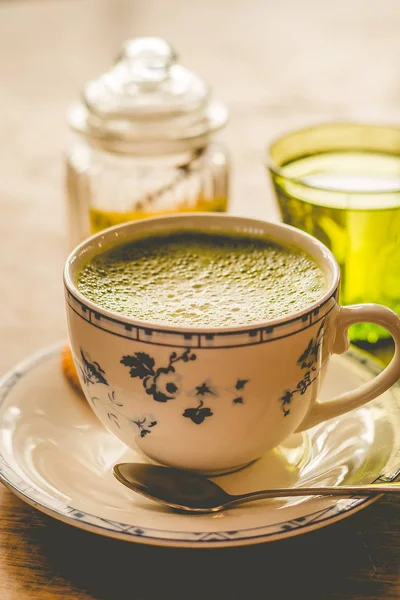 Kahverengi şeker ve tarafında bir bardak su ile bir çin fincan yeşil çay matcha soya latte — Stok fotoğraf