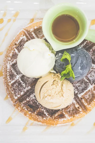 Waffle with Triple Scoop Ice-cream on top and served with maple syrup on white china plate — Stock Photo, Image