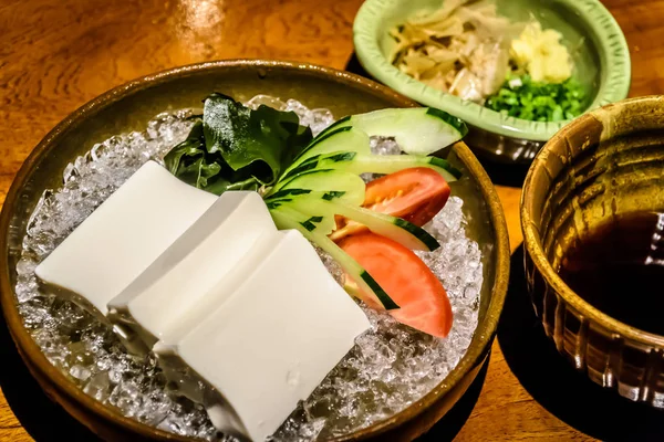Tofu on ice appetiser with kombu kelp, cucumber, tomato and soy sauce on the side — Stock Photo, Image