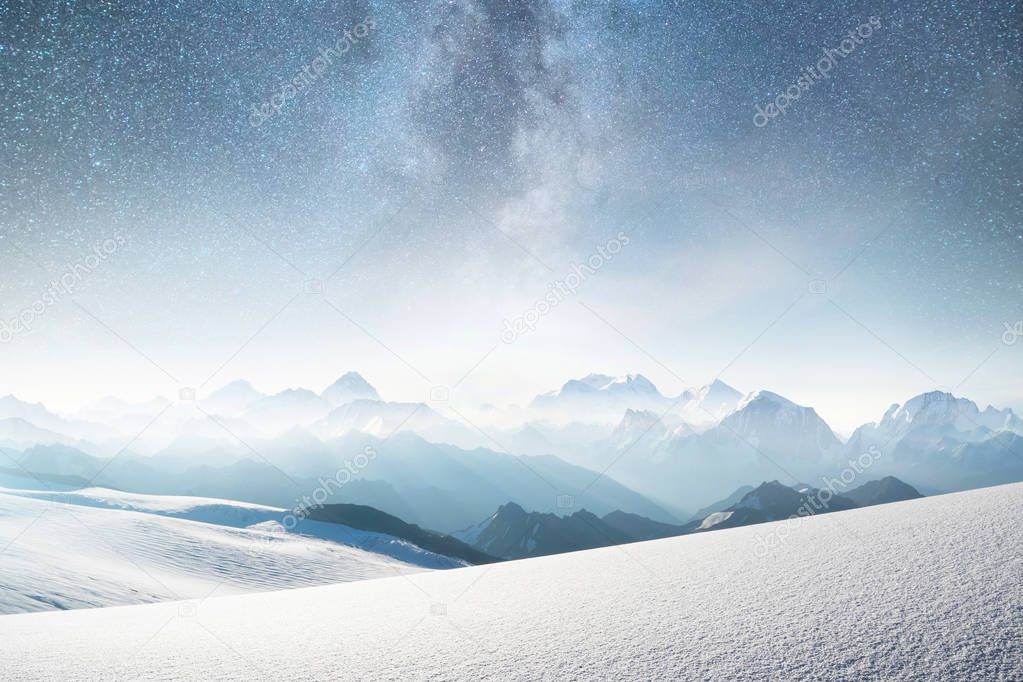 Mountains and sky with stars. Natural landscape in mountains region at the winter time. Starry sky and high peak.