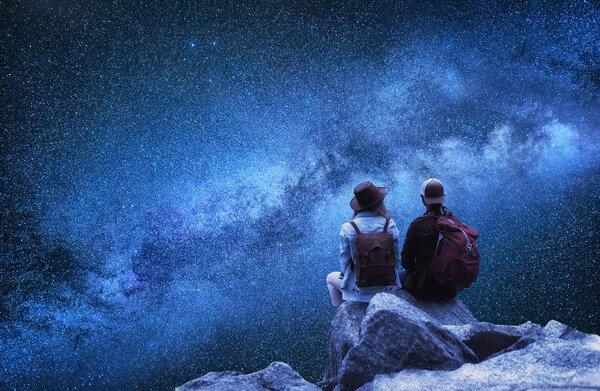 Travelers couple look at the stars. Travel and active life concept with team. Adventure and travel in the mountains region