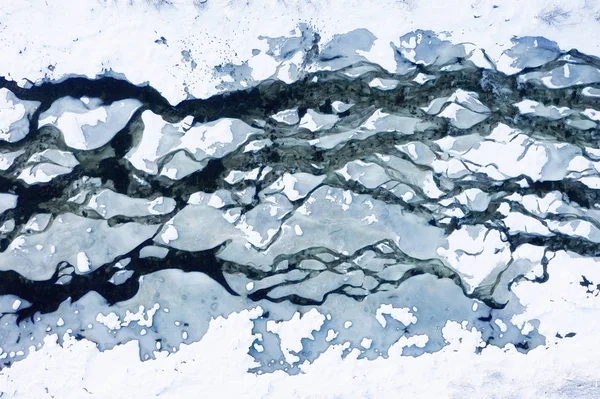 Aerial view on the river at the winter time. Natural winter landscape from air. River under snow a the winter time. Landscape from drone
