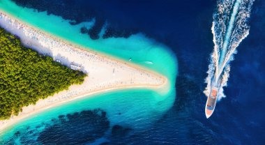 Croatia, Hvar island, Bol. Aerial view at the Zlatni Rat. Aerial view of luxury floating boat on blue Adriatic sea at sunny day. Travel - image clipart