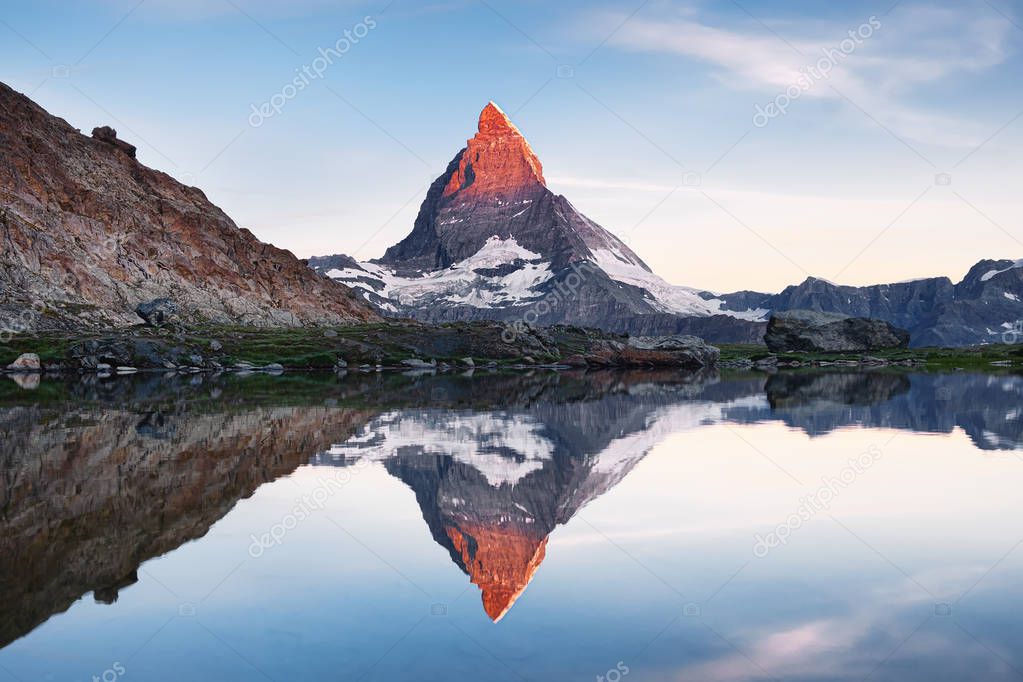 Matterhorn and reflection on the water surface during sunrise. Beautiful natural landscape. Switzerland travel - image
